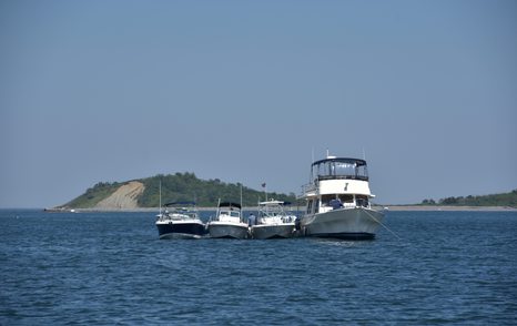 small boats rafted up on anchor