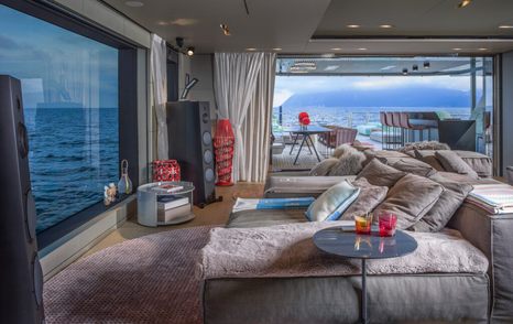 Main saloon on CdM Flexplorer 146 Maverick with large panoramic window overlooking the sea