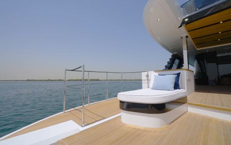 Sun lounger on the Gulf Craft Majesty 145 side terrace beside the aft deck pool