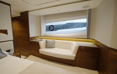 Princess S65 Mk2 owner's cabin sofa beneath the starboard hull window