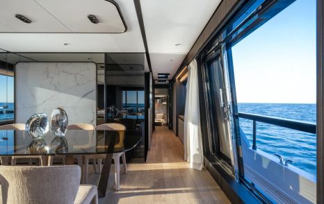 Ferretti 940 motor yacht main saloon with glass sliding doors and dining area 