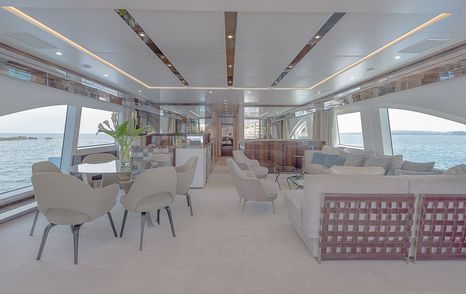 Superyacht Chrimi III's upper deck with circular table and seating area