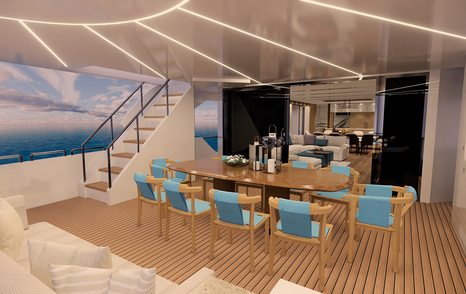 al fresco dining area with wooden table and blue chairs on the main deck aft of FD92 yacht