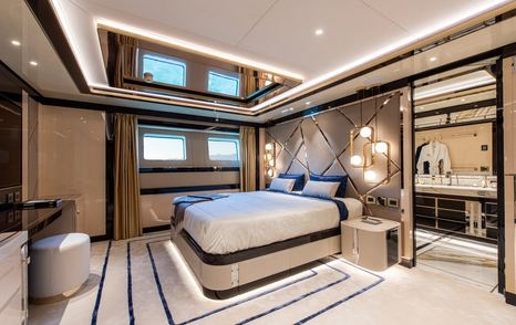 Large double bed in cabin on superyacht STEFANIA with ensuite visible