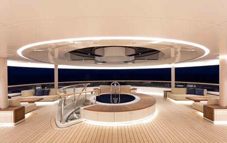 Superyacht Flying Fox aft deck with shaded seating and circular stairwell