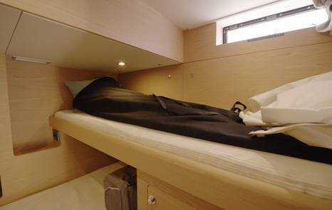 Beneteau Grand Trawler 63 upper crew berth with hull window and practical cabin layout