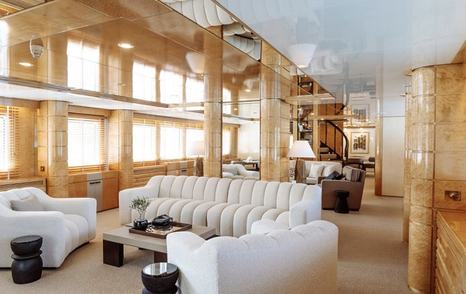 Feadship Superyacht Kassandra's main saloon with white seating and wooden coffee table 