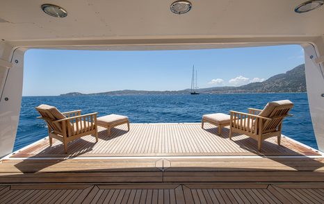 Superyacht Wedge Too’s fold-down bathing platform with lounge chairs overlooking the sea