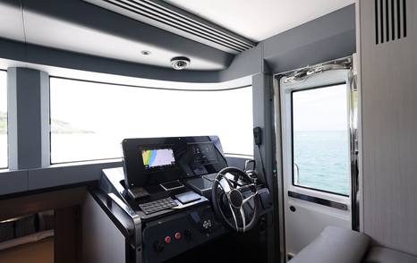Sirena 48 lower helm station with forward windscreen and side access door
