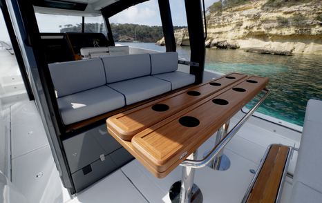 Aiata-Wayfinder-38-Suntop-Review-cockpit-table-with-cupholders-and-seating-detail