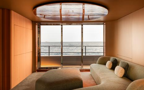 Rossinavi Superyacht Heed salon with curved grey seating