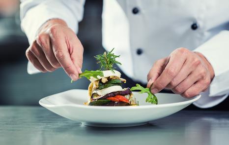 yacht chef finishing a dish