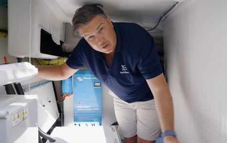 Jack Haines inspecting the Fairline Targa 47 GT engine room during the YachtBuyer review