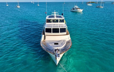 Fleming 85 anchored bow-on in tropical waters showing enclosed pilothouse design