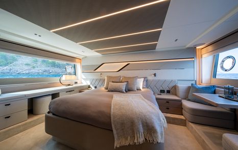 Overview of the master cabin onboard the Sunseeker 75 Sport Yacht, central berth facing forward with a window to both port and starboard