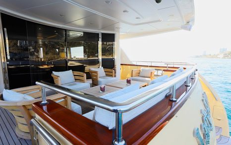 Motor yacht Lady Alina's main deck aft with dining seating