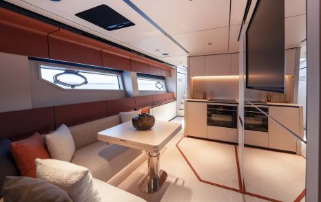 Itama 70 motor yacht interior with L-shaped sofa and TV