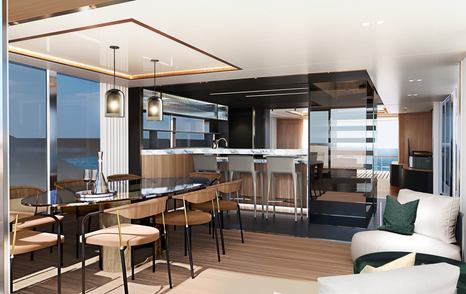 Interior dining area onboard Sunseeker Ocean 156. Dining table to port side with galley in background and seating to starboard.