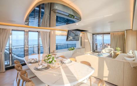 Gulf Craft Majesty 100 Terrace motor yacht main saloon dining area with marbled white dining table 