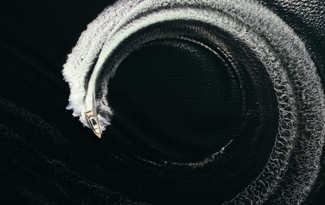 Aerial view of XO EXPLR 44 carving tight high-speed turn