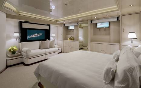 Superyacht Eternity cabin with mounted TV and seating area 