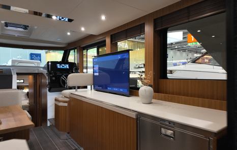 Greenline 42 saloon with pop-up TV rising from galley counter and integrated storage