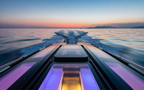 View across deckhouse of Wooden Boats WB14 limousine tender with sea and sunset in the background