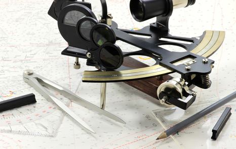 sextant with nautical chart and plotting equipment