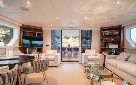 Superyacht Envy's interior seating with sliding glass doors