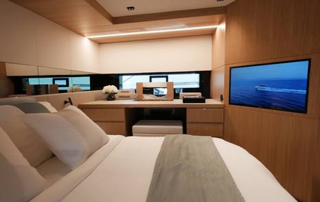 De Antonio D60 owner’s cabin showing wall-mounted TV and dressing table