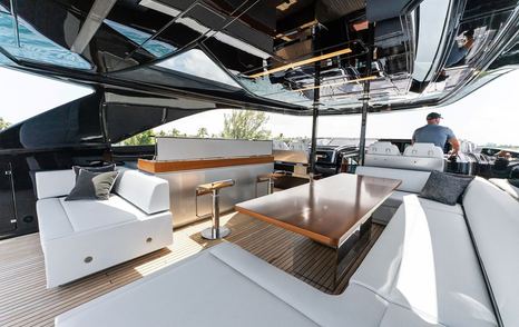 Motor yacht Chop Chop's upper deck shaded seating and bar area