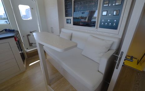 Numarine 40MXP wheelhouse seating area beside the helm with adjacent captain's cabin