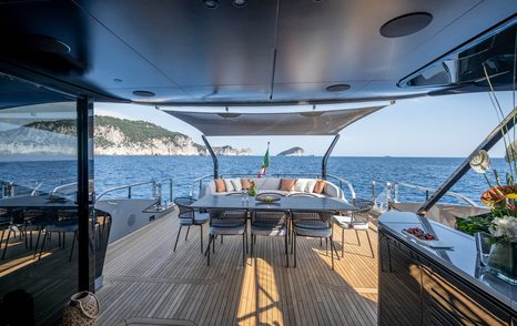 Mangusta 104 REV motor yacht sundeck with shaded alfresco dining