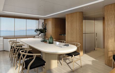 Interior dininga area onboard Benetti superyacht OPUS. Long dining table surrounded by chairs with black cushions.