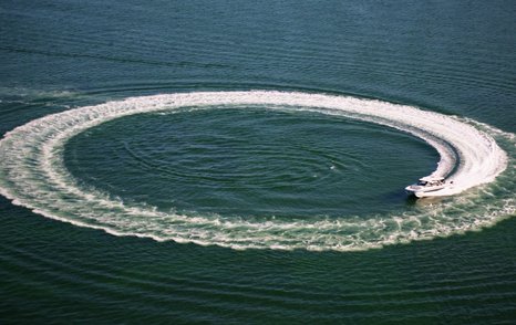 Aquila 45 Sport turning at speed creating circular wake pattern, demonstrating high-performance handling of this 50-knot powercat
