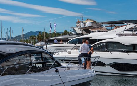 Two men standing on the bow of a superyacht in Vieux Port marina