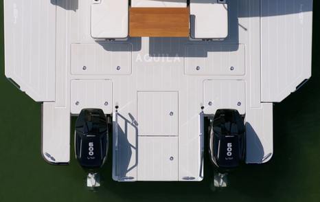 Aquila 45 Sport overhead view of aft deck and swim platform, showing twin outboards and central walkthrough layout