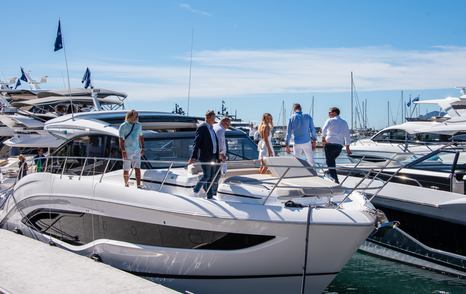 A Princess yacht with people exploring the bow at the Cannes Yachting Festival