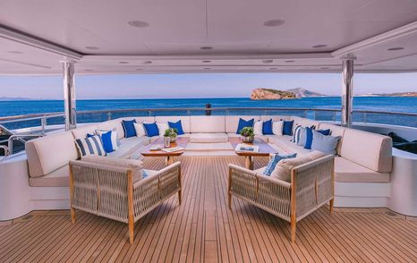 Superyacht IDyllic main aft deck shaded U-shaped seating