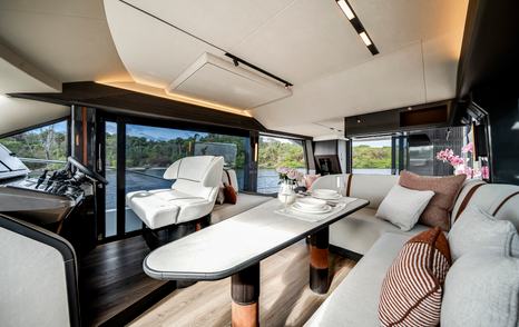 Galeon 520 Fly yacht main saloon sofa and helm 