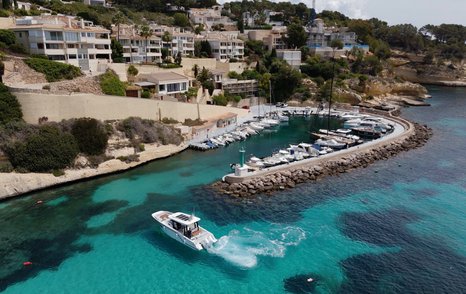 Aiata-Wayfinder-38-Suntop-Review-aerial-view-entering-marina-with-coastal-backdrop