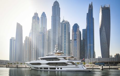 Gulf Craft Majesty 120 entering Dubai Harbour Marina, overlooking Dubai skyscrapers