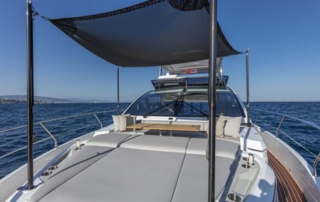 Overview of Pearl 62 foredeck, large sunpads with bimini overhead for shade, surrounded by sea