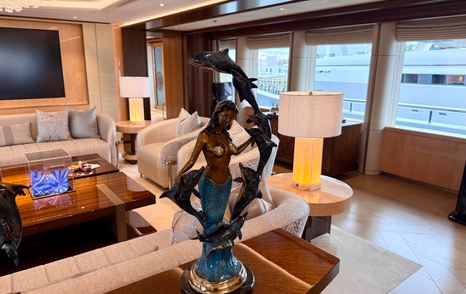 Decorative sculpture and seating area in the main saloon of the Amels 242 Casino Royale.