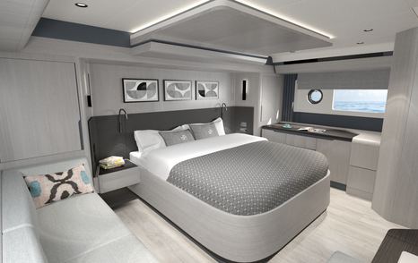 Master cabin onboard Sirena 48, central berth with wide glazing in background and white sofa in foreground.