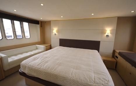 Princess V62 owner's cabin with vertical portholes and sofa