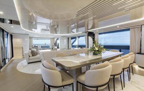 Mangusta Oceano 50 motor yacht main saloon dining area with white chairs and table