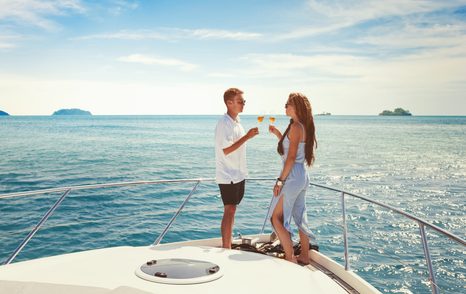 Couple drinking champagne on deck