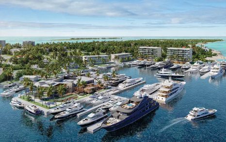 Overview of  Hurricane Hole Superyacht Marina at Paradise Landing, with many superyachts docked, surrounded by sea and hotels