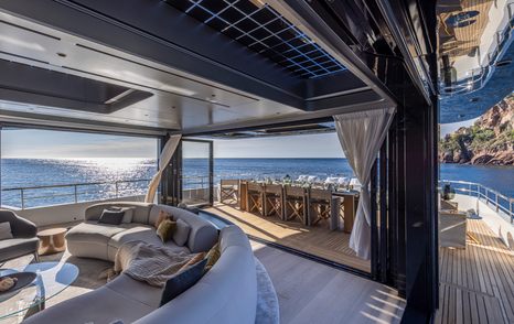 Arcadia A96new Superyacht main saloon with curved seating and glass sliding doors 